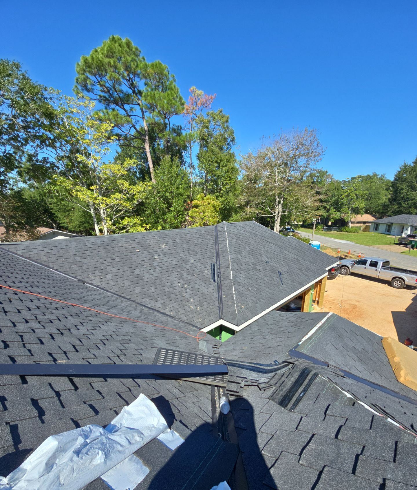 Presidential Shake designer shingles going on over the metal valleys of the Ocean Springs new build