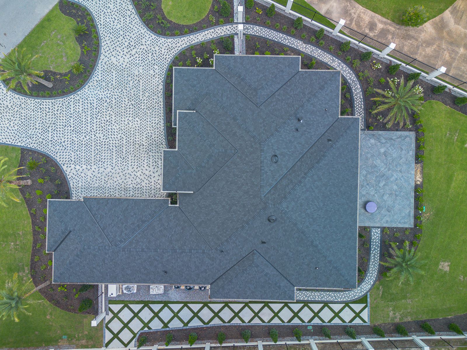 Top-down aerial of the whole roof and paver drive of the new Ocean Springs home