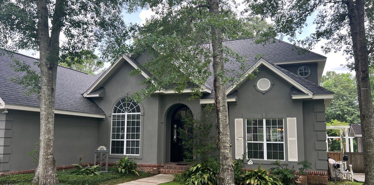 The arched front entry of the Biloxi home under the completed Georgetown Gray FORTIFIED roof