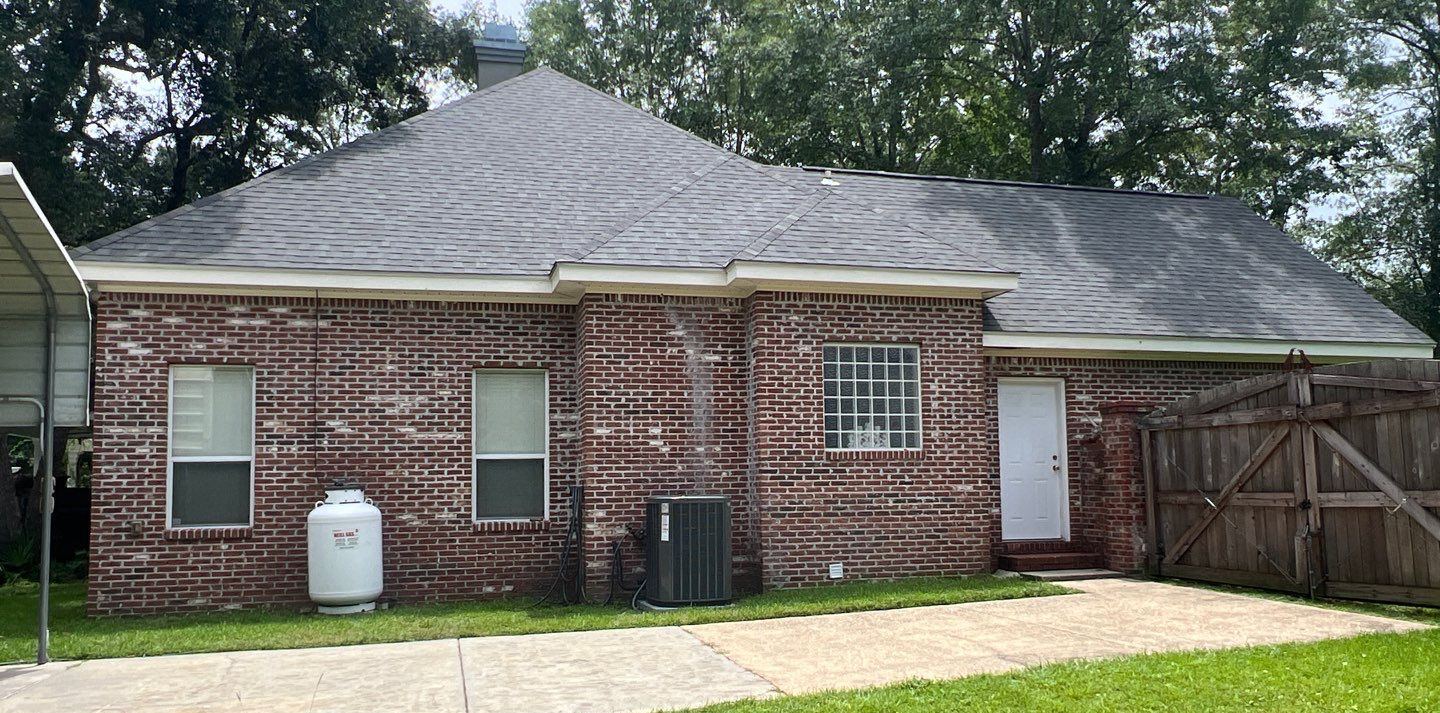 Rear of the brick Biloxi home under the new Georgetown Gray shingle roof