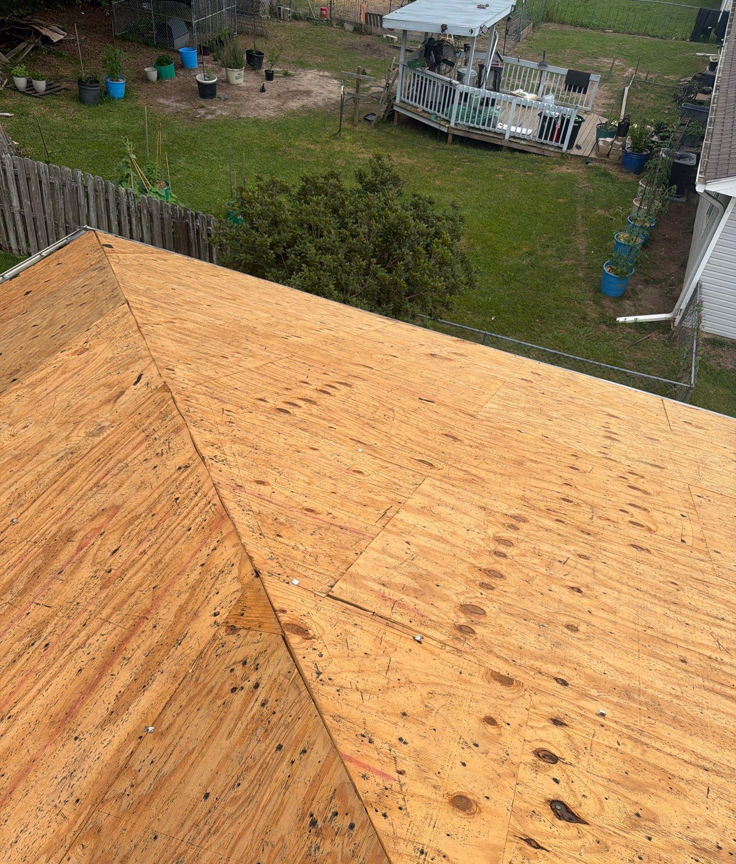 New plywood on the torn-off hip roof of the Long Beach home where the deck needed replacing
