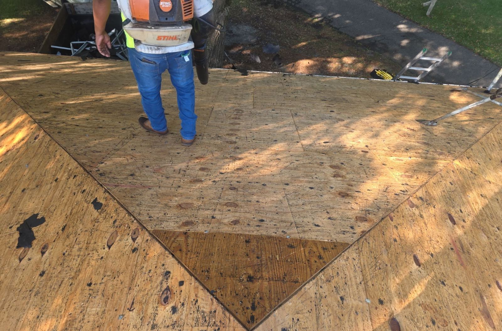 A Gulf South Roofing crew member on the new plywood roof deck of the Ocean Springs main house during the replacement