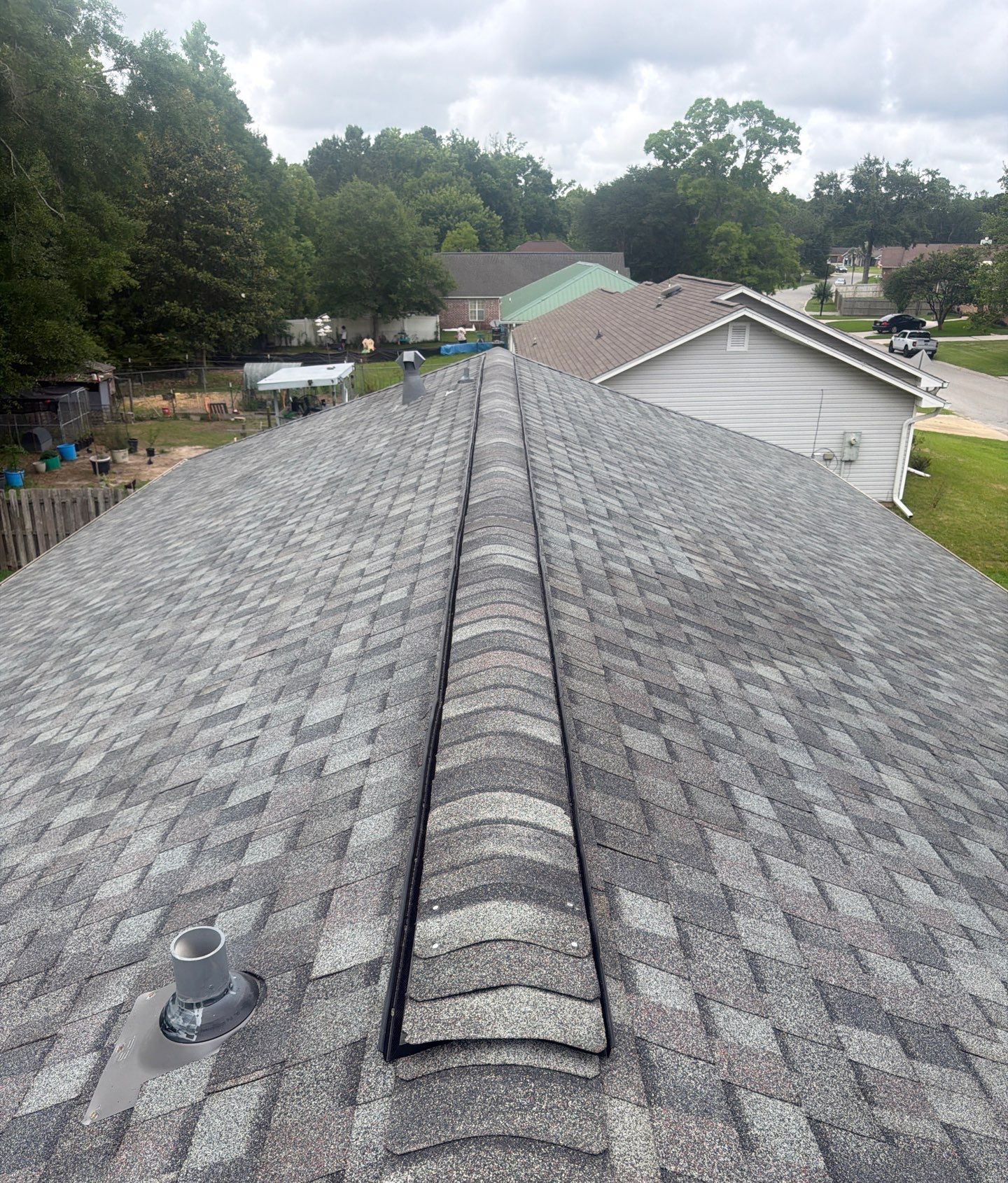 Colonial Slate shingles and the ridge vent going on along the ridge of the Long Beach roof