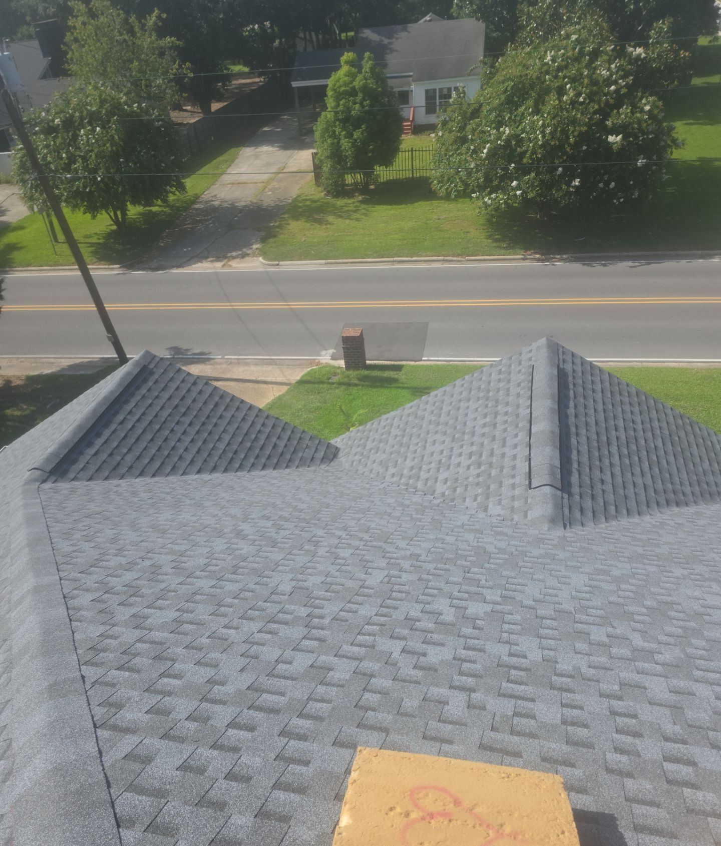 The new hips and ridge of the Pascagoula roof looking toward the street on completion day
