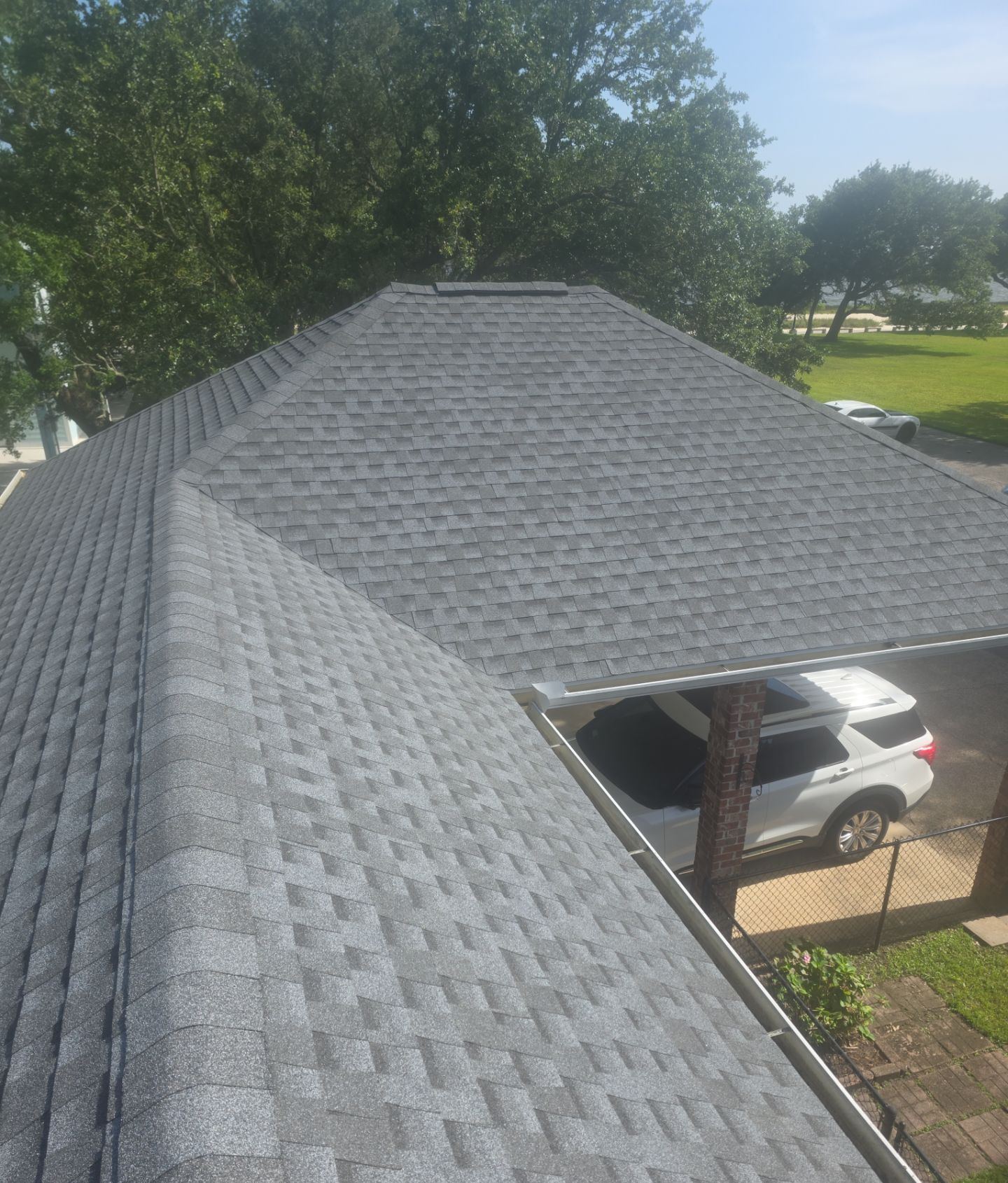 Looking down the new Pewter Gray shingle roof of the Pascagoula home toward the carport on the afternoon it was finished