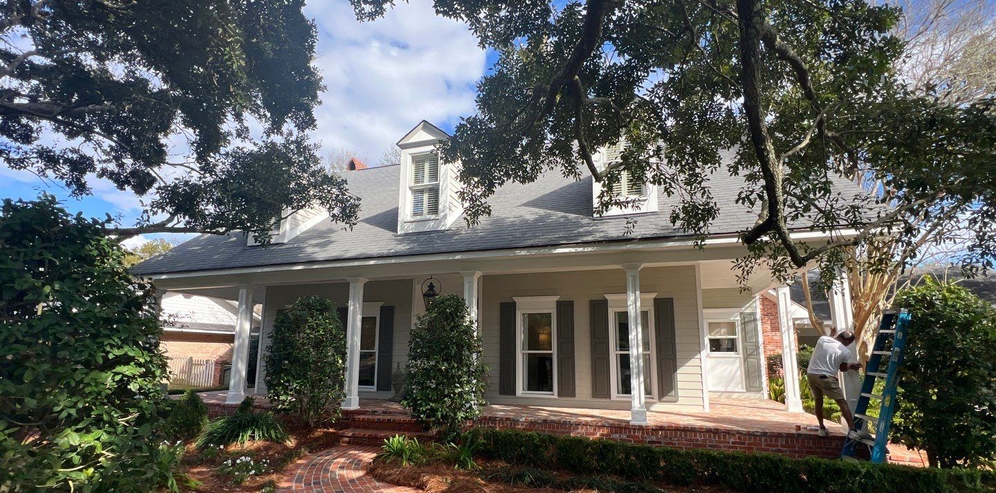 Front of the Gulfport home from the brick walk, both dormers re-flashed under the new Pewter Gray FORTIFIED shingle roof
