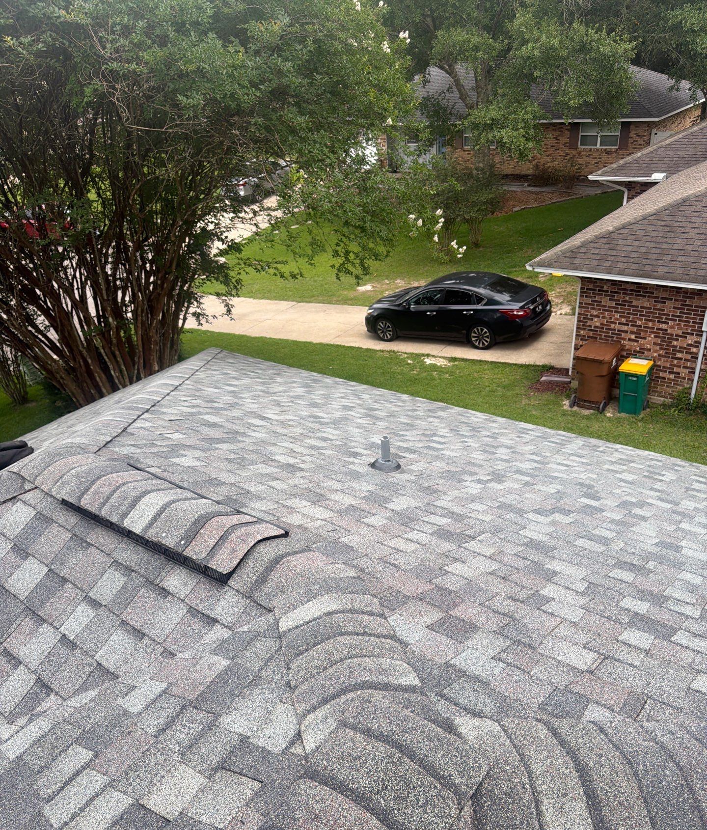 Looking down the new Colonial Slate shingle roof of the Long Beach home to the street