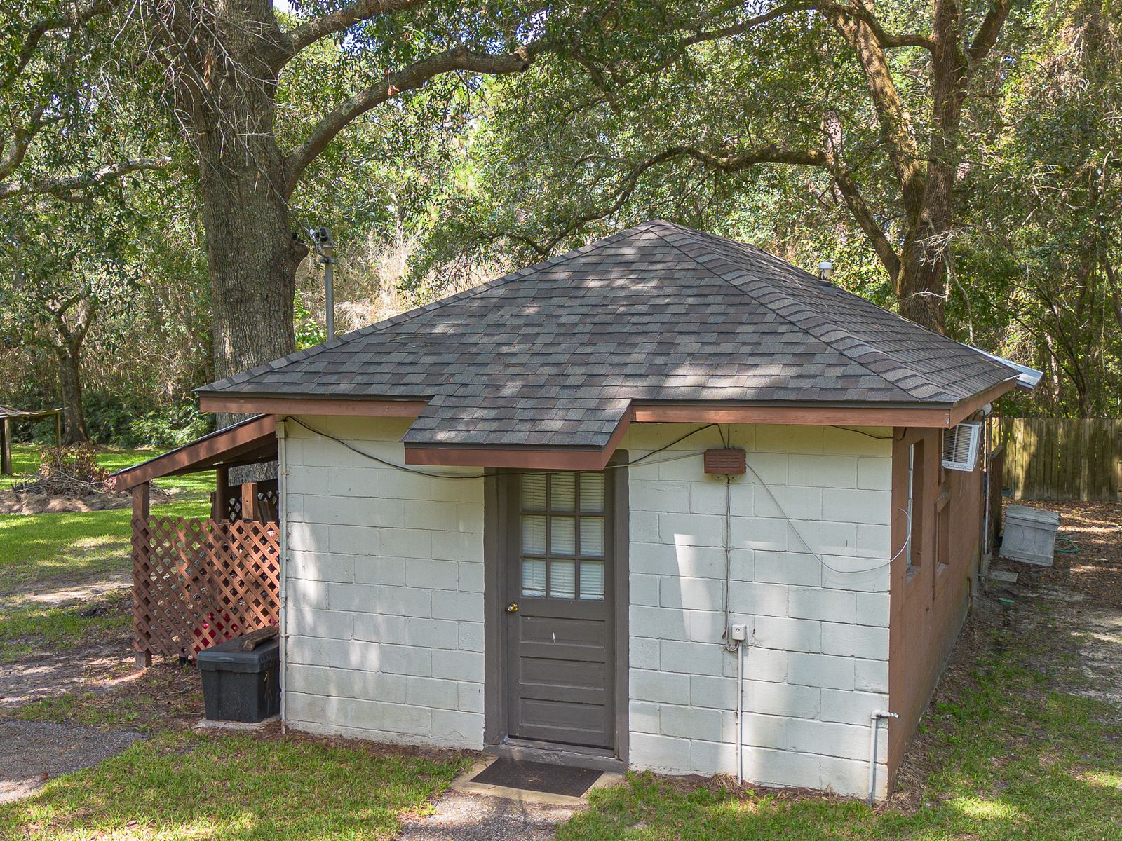 The detached block office building with its new hip roof in Weatherwood shingles