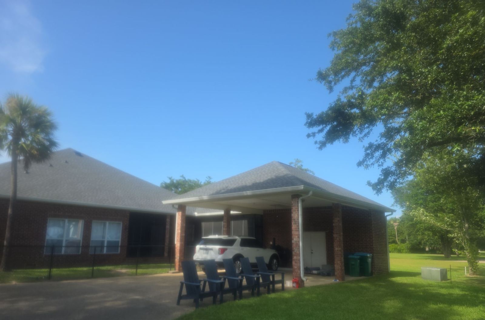 The brick Pascagoula home and its carport under the completed FORTIFIED Pewter Gray shingle roof