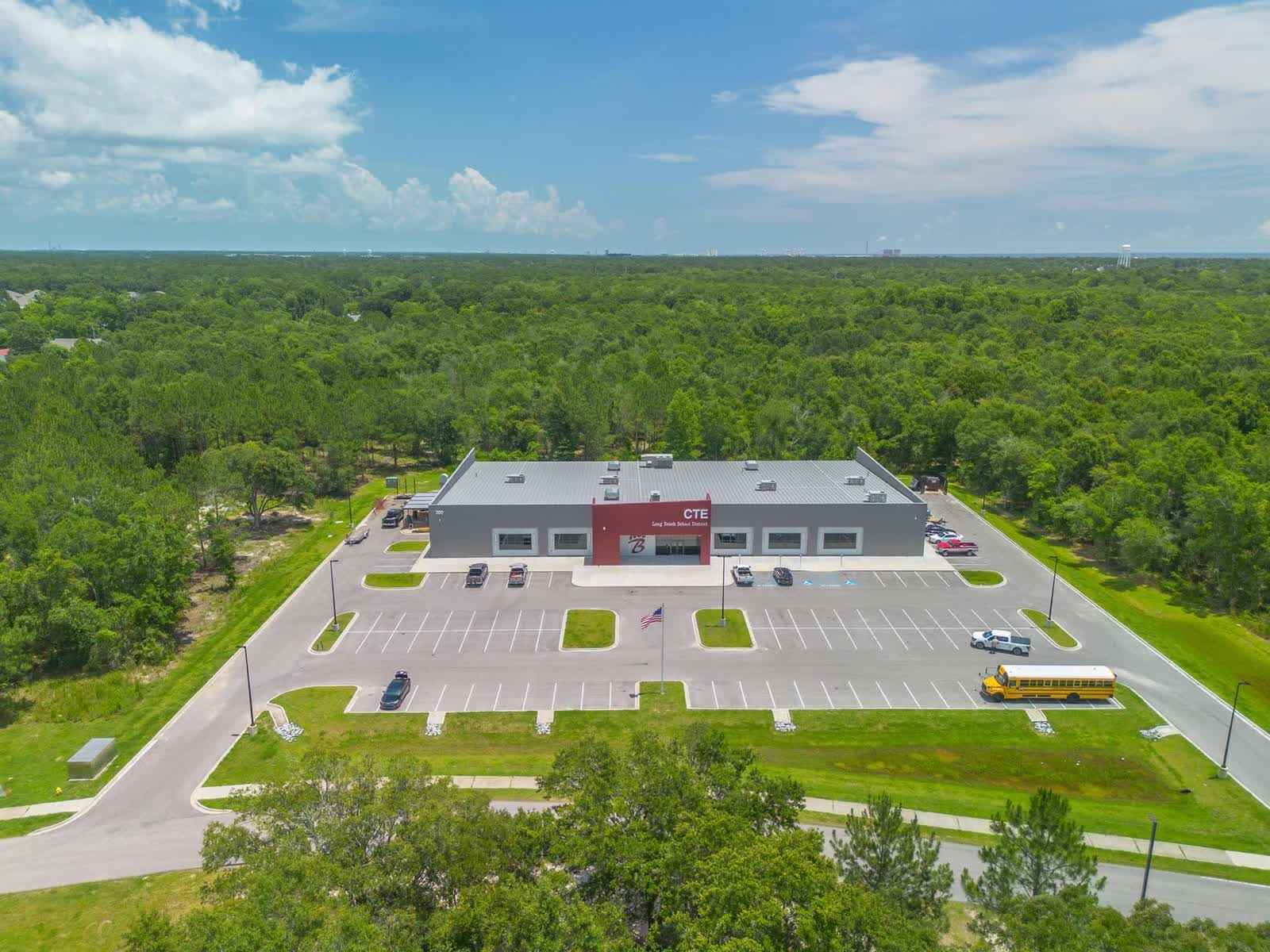 Aerial of the Long Beach School District CTE building with its full metal roof system installed by Gulf South Roofing crews