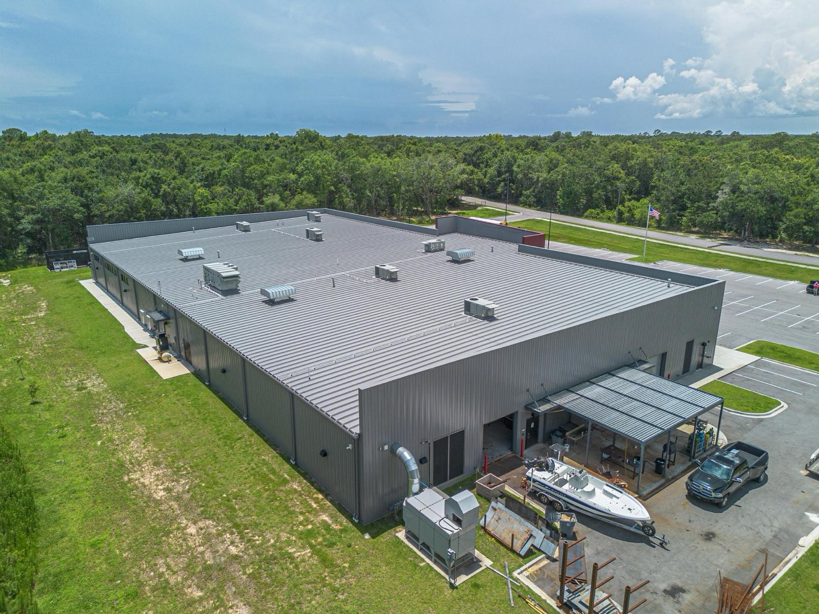 Wide aerial of a commercial metal roof with rooftop units installed by Gulf South Roofing in Long Beach Mississippi