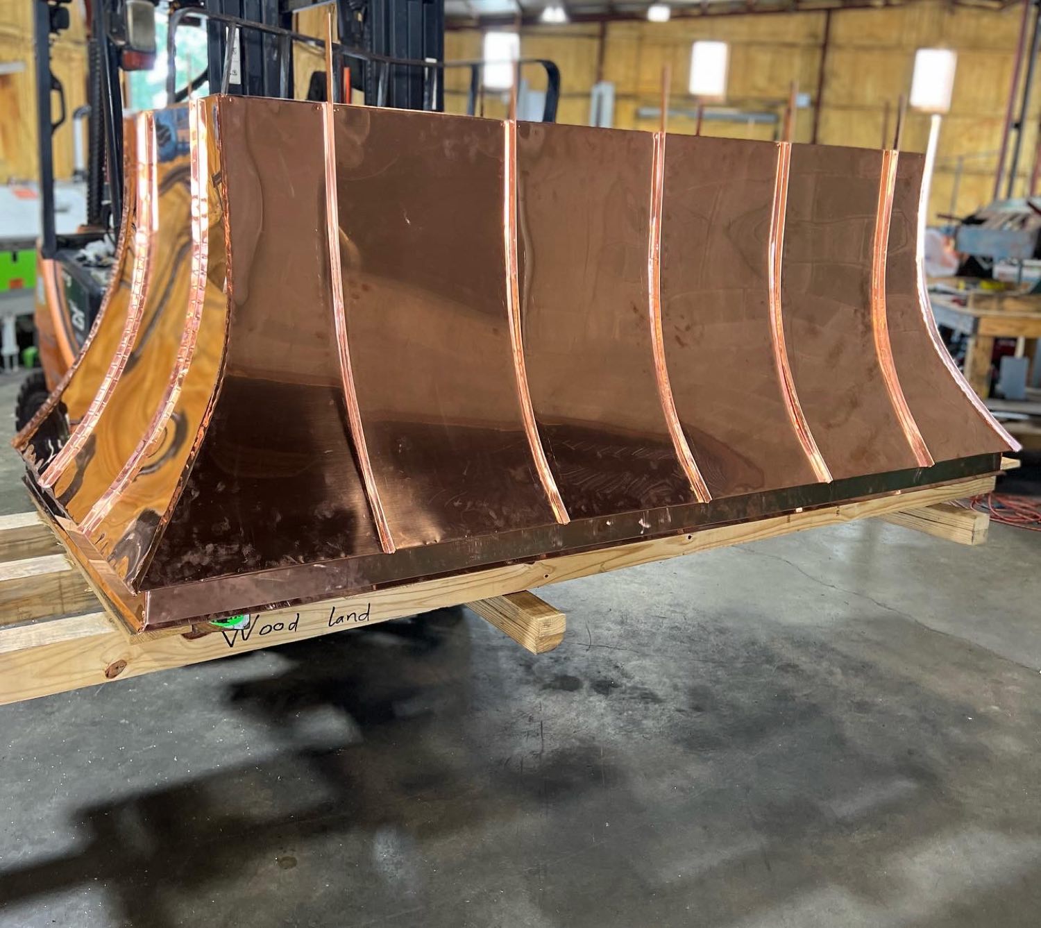 Copper chimney hood frame taking shape on the bench at the Gulf South Roofing shop