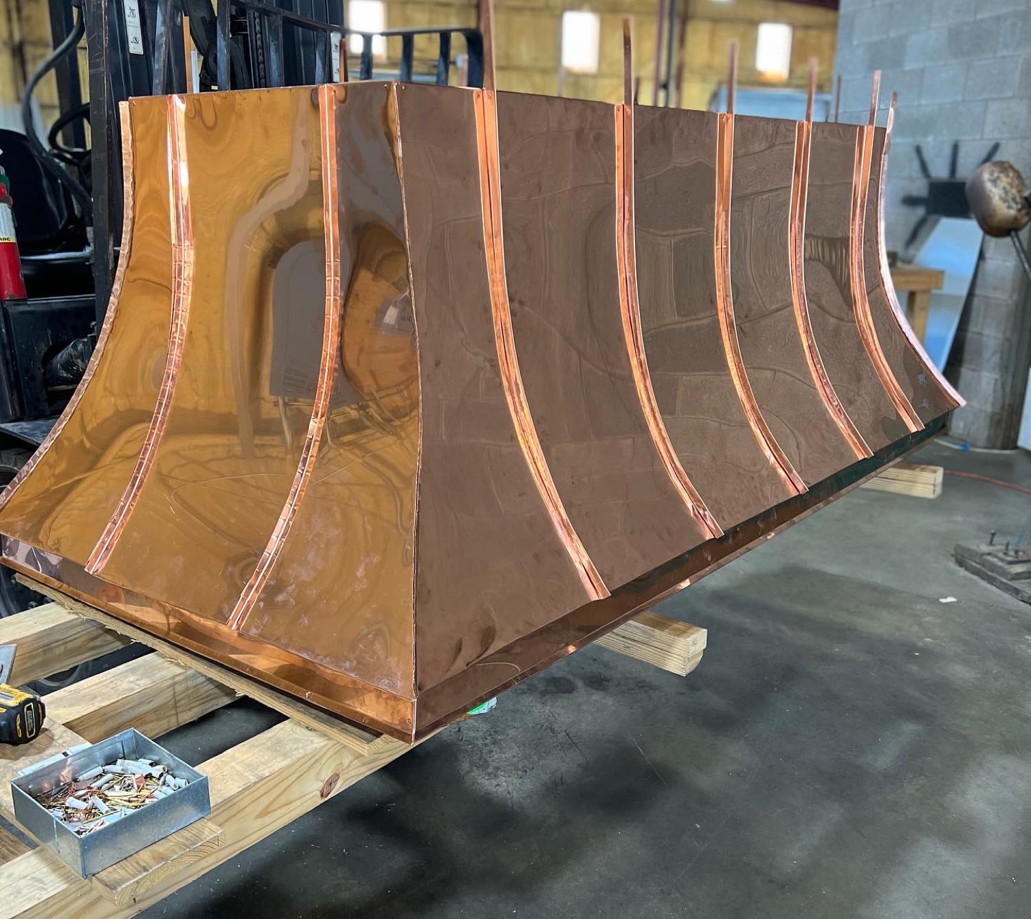 Copper panels formed for a custom chimney hood in the Gulfport sheet metal shop