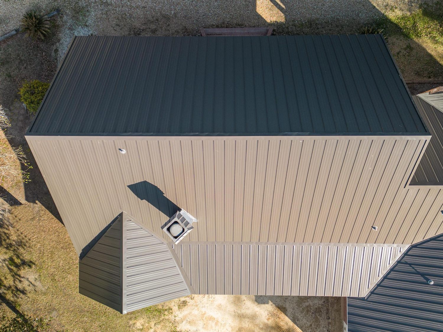 Front elevation of a home with a new standing seam metal roof by Gulf South Roofing
