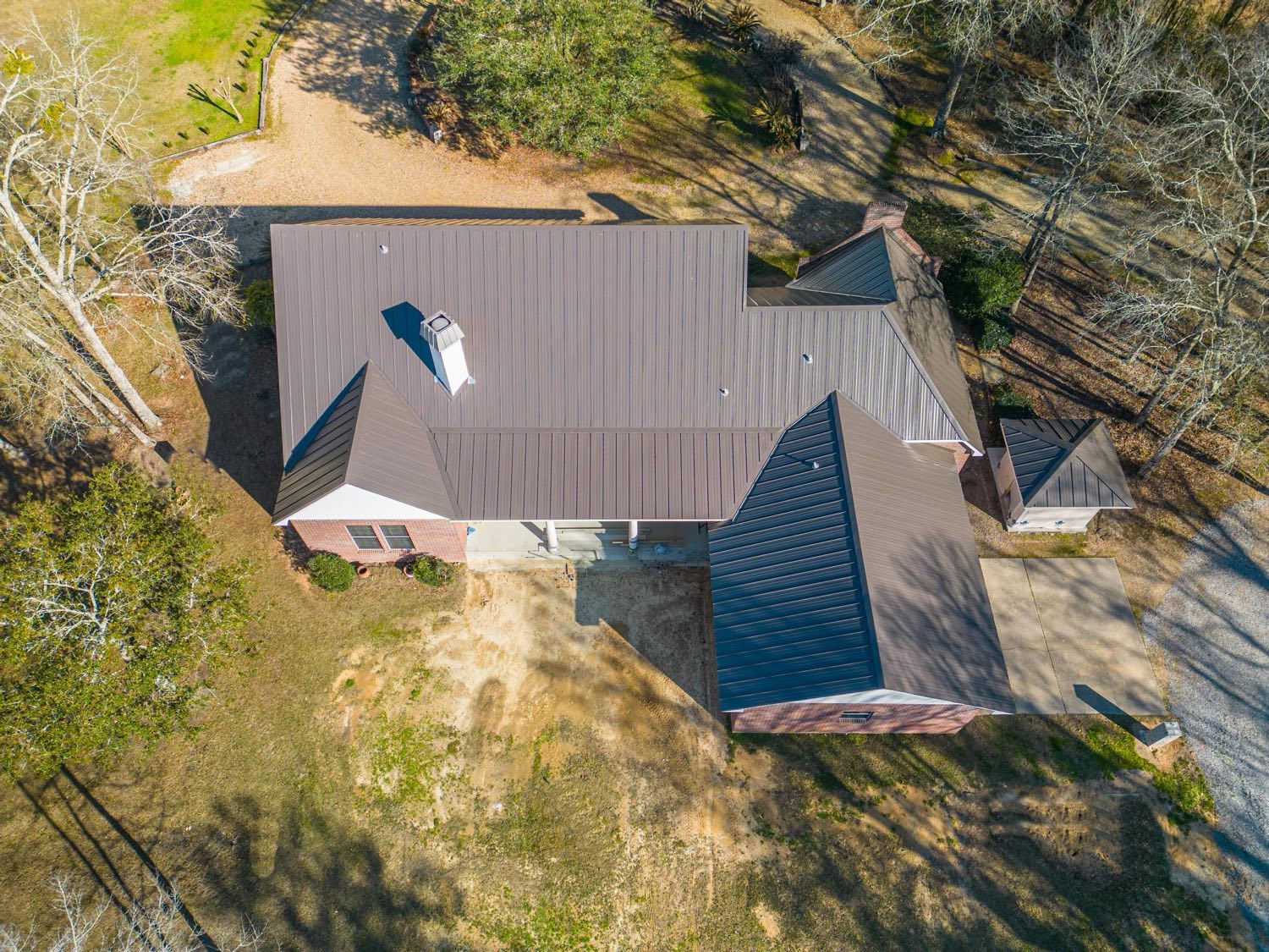 Shop-formed ridge and trim on a standing seam metal roof