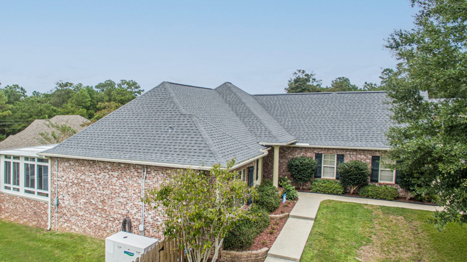Completed architectural shingle roof replacement across the full elevation of a Diamondhead Mississippi home