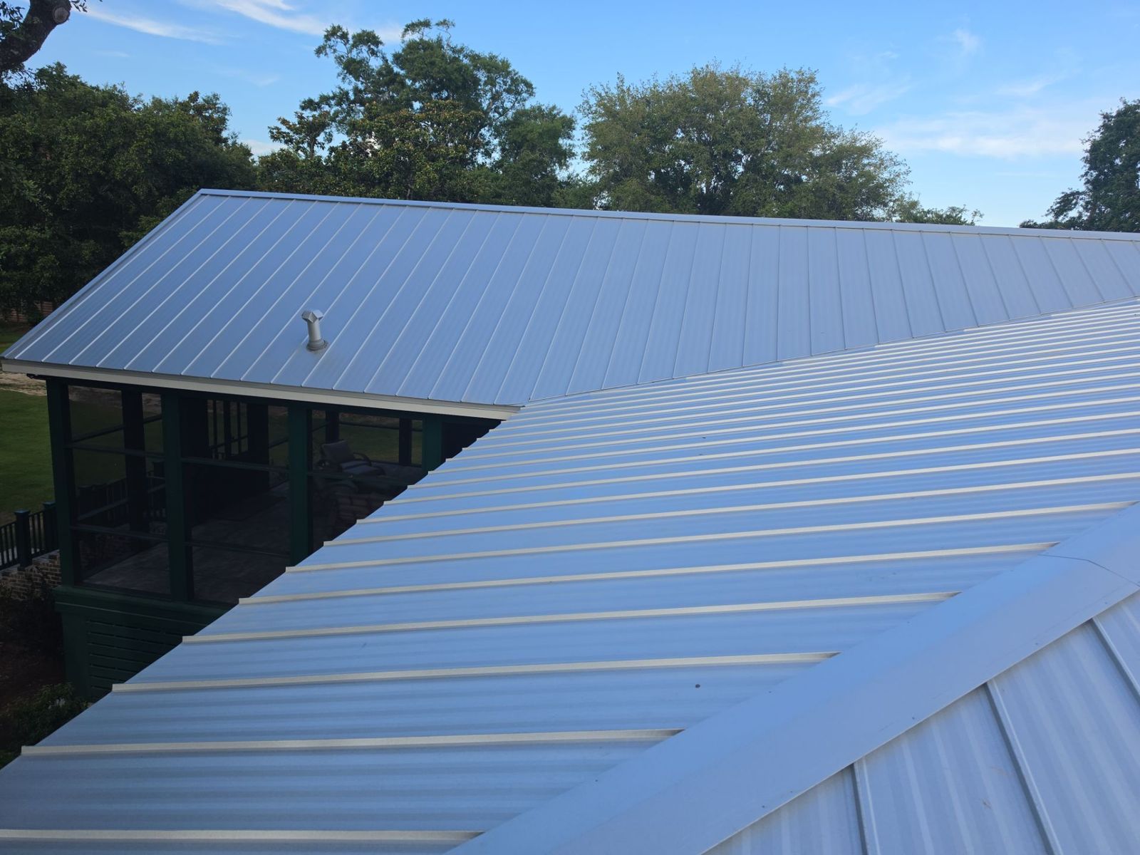 Sealed ridge and pipe penetration on a galvalume standing seam roof over a Gulf Coast screened porch